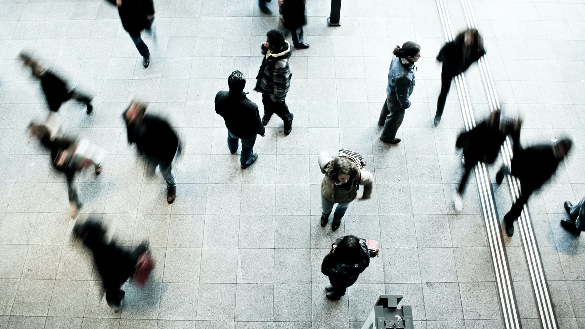 People walking on a concrete floor