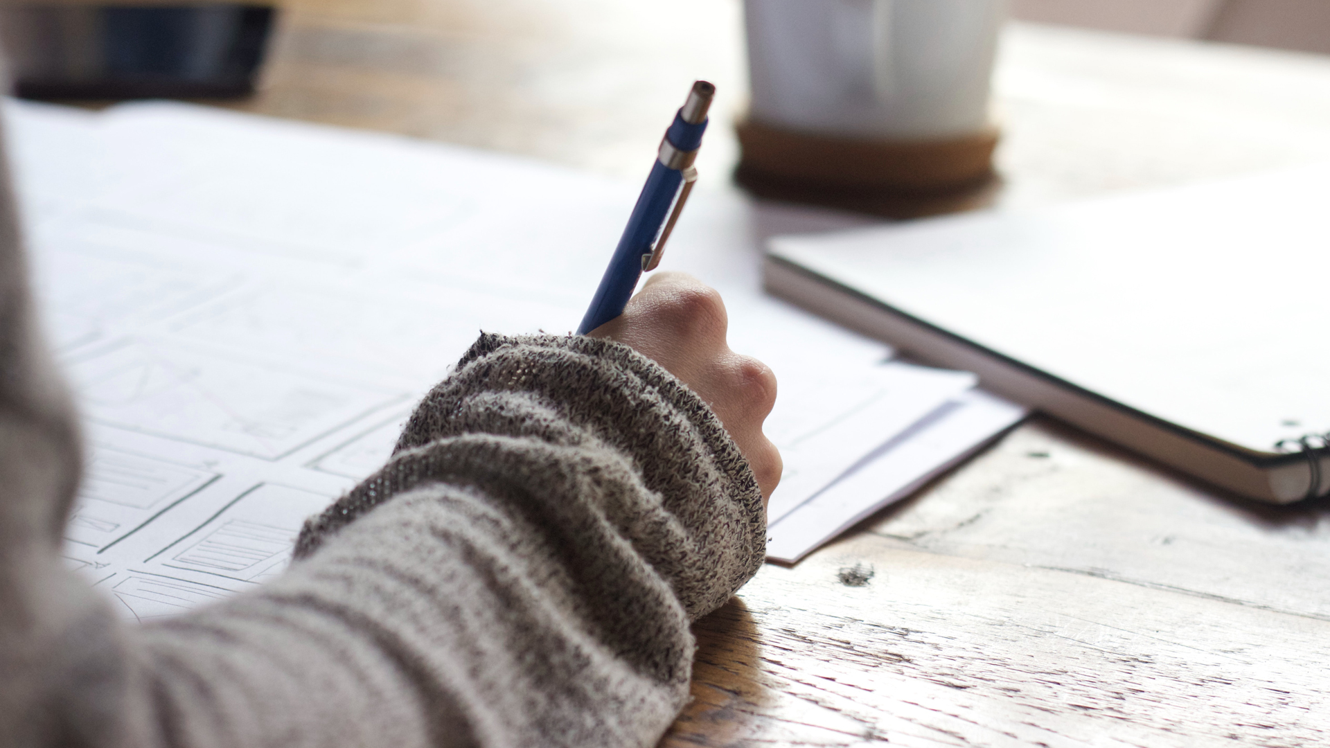 Close up of a woman writing in a notebook