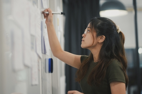 Student writing on a whiteboard