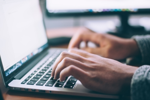 Close up of a man using a laptop