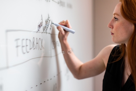 Woman writing on a white board