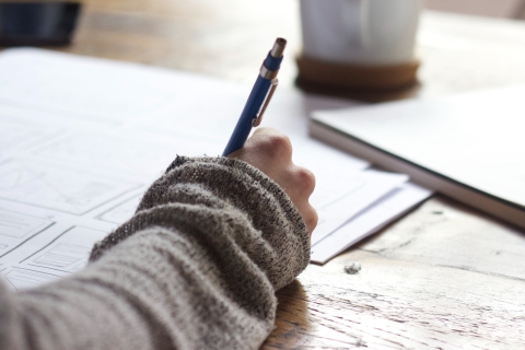 Close up of a woman writing in a notebook