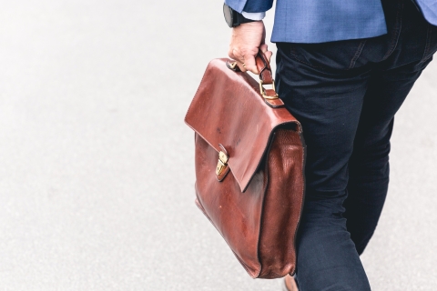 Close up of man walking with a briefcase